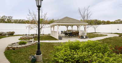 Outdoor gazebo with seating area in landscaped garden