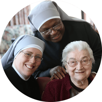 Residents and staff posing together in a common area