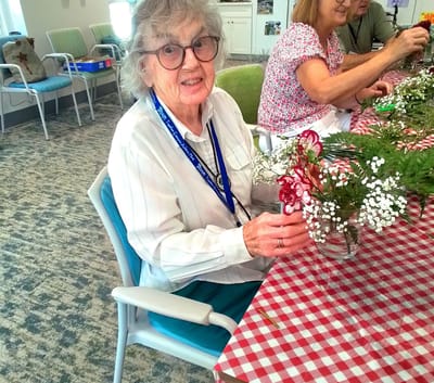 Resident engaging in a flower arranging activity