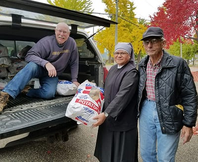 Volunteers loading supplies from a truck