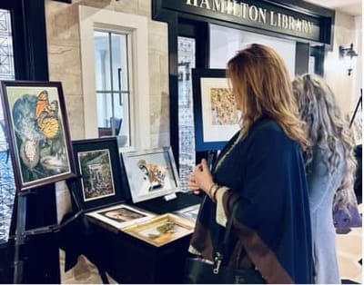 Residents admiring artwork in the library