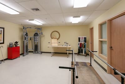 Interior view of a rehabilitation therapy room with equipment