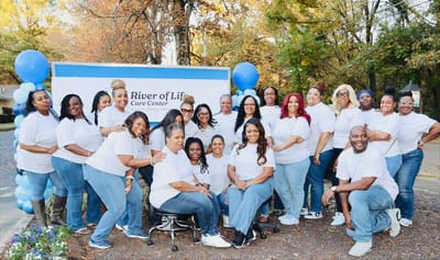 Staff gathering outside the River of Life Care Center