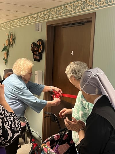 Residents participating in a ribbon-cutting ceremony