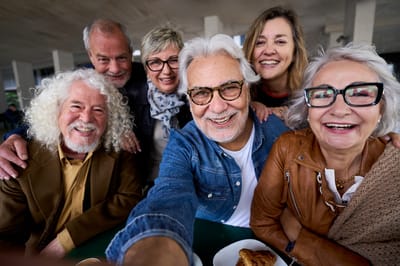 Residents enjoying a group photo together outdoors