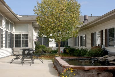 Serene outdoor courtyard with seating and a pond