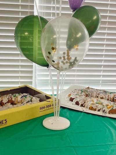 Decorative table setup with food and balloons for an event