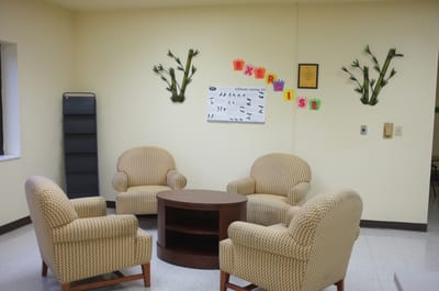 Common area with seating and exercise poster