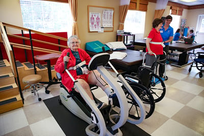 Residents engaged in exercise activities with staff support