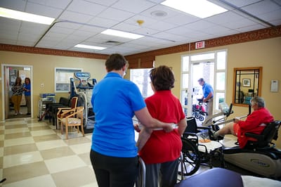 Staff assisting residents in an activity room
