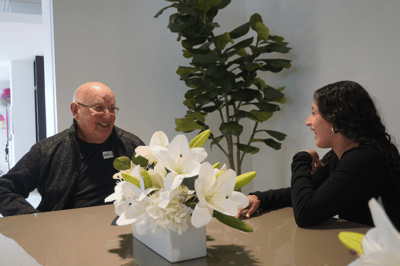Senior resident enjoying conversation with staff member