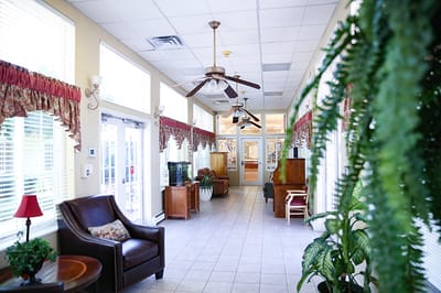 Bright interior hallway with seating and plants