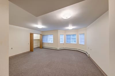 Empty interior room with windows and closet space