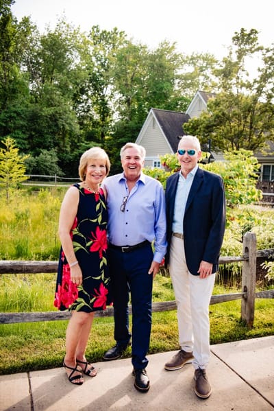 Three people posing in an outdoor area