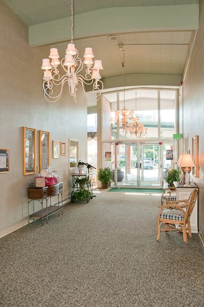 Bright lobby area with chandeliers and seating