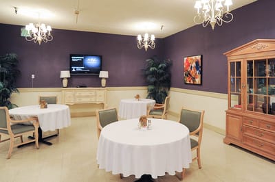 An elegant dining room with tables set for meals