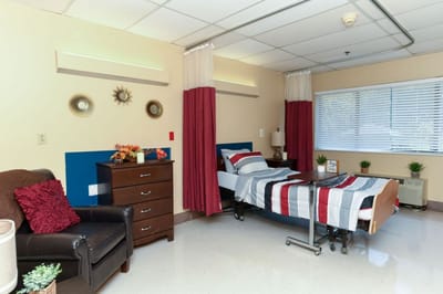 Cozy private resident room with bed and furnishings