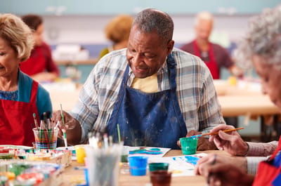 Residents participating in a painting activity
