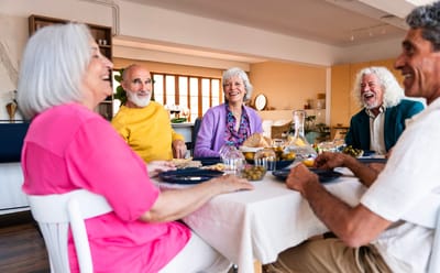 Seniors enjoying a meal together at a dining table