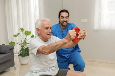 Senior resident exercising with a staff member