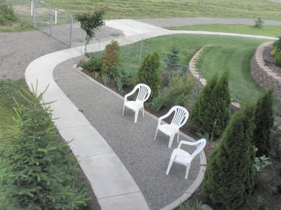 Outdoor seating area with chairs and greenery