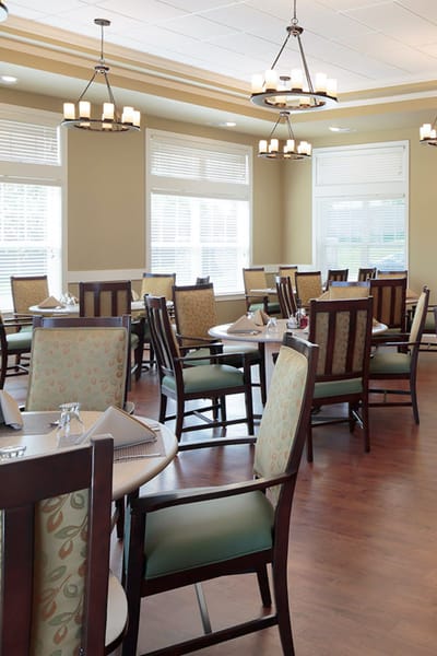 Dining area with chairs and tables set for meals