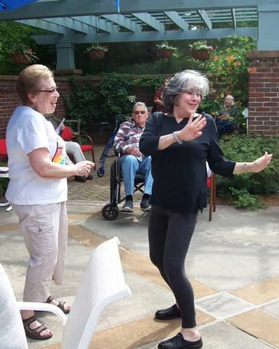 Residents enjoying a dance outside in the garden