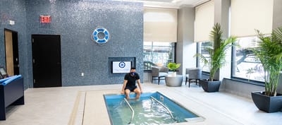 Resident enjoying a hydrotherapy pool in a wellness area