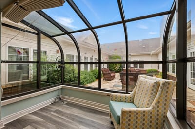 Bright sunroom with comfortable seating and garden views