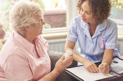 Staff assisting a resident with medication
