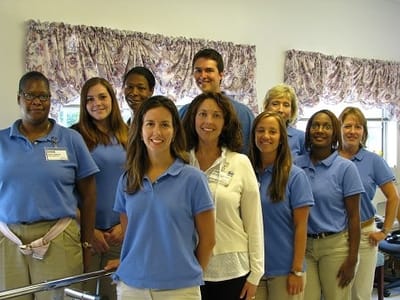 Staff members posing together in a common area