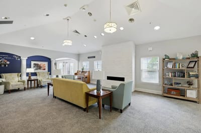 Bright common area with comfortable seating and bookshelves
