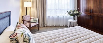 Cozy interior of a resident room with a bed and seating area