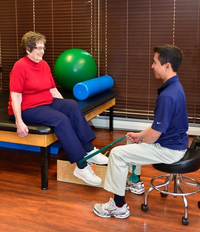 Physical therapy session with a resident and staff member