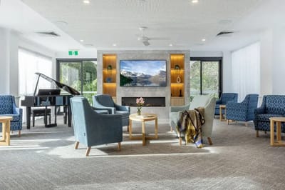 Bright common area with seating and piano