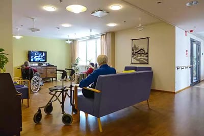 Residents enjoying time in a common area with seating