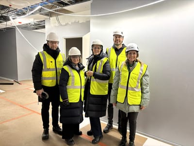 Group of staff and residents in hard hats at the facility