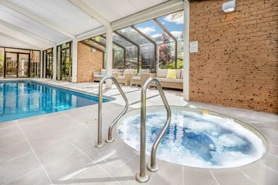 Indoor pool area with jacuzzi and seating
