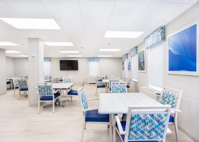 Bright and spacious common area with tables and chairs
