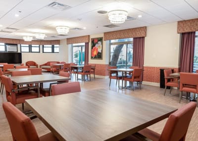 Bright and spacious common area with tables and chairs