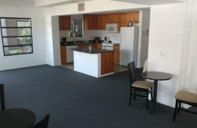 Common area with kitchen and dining tables