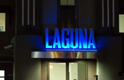Exterior shot of Laguna's illuminated sign at night