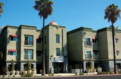 Exterior view of Laguna Senior Apartments with palm trees