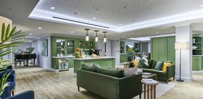 Bright common area with seating and piano