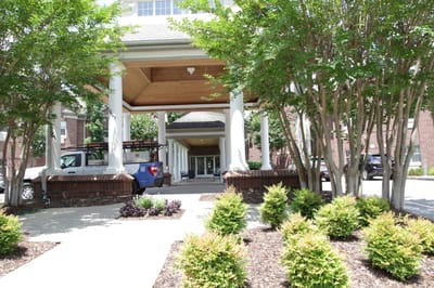Entrance of a senior living facility with landscaped pathway