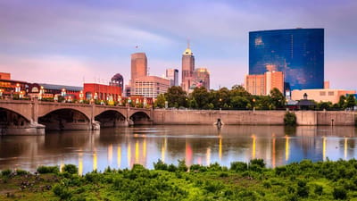 Westside Garden Plaza, Assisted Living in Indianapolis, IN — City skyline at dusk with a river in the foreground