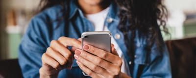 Westside Garden Plaza, Assisted Living in Indianapolis, IN — Person using a smartphone indoors