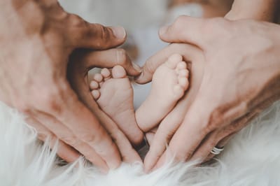 Westside Garden Plaza, Assisted Living in Indianapolis, IN — Hands forming a heart shape around a baby's feet