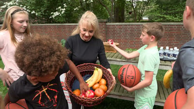 Westside Garden Plaza, Assisted Living in Indianapolis, IN — Residents participating in an outdoor activity with fruits and basketballs