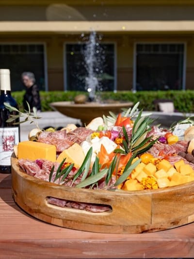 A beautifully arranged charcuterie platter outdoors